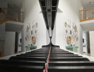 Piano keys with home reflected as well as the keys in the piano
