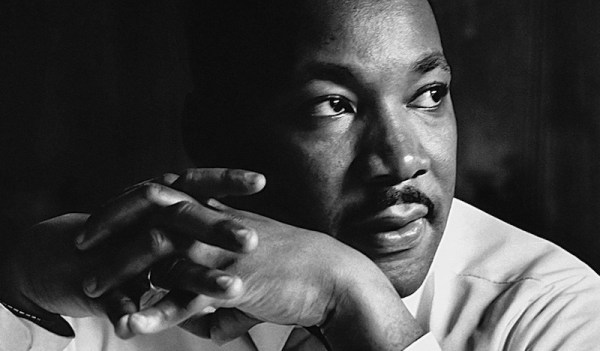 MLK looking left with hands intertwined