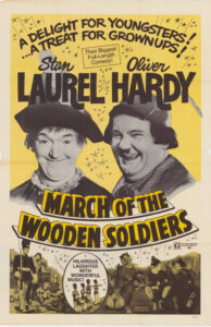 Yellow poster for March of the Wooden Soldiers featuring Stan Laurel (left) and Oliver Hardy (right)