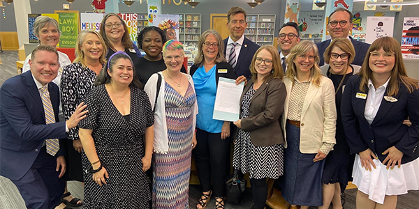 Group of library executives, librarians and government leaders celebrating the signing of Illinois House Bill 2789