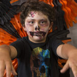 Child with face painted like a zombie