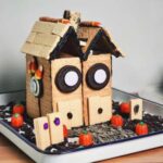 Gingerbread house made from graham crackers and Halloween candy