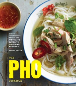 A bowl with rice noodles, chicken, tomatoes, and jalapenos