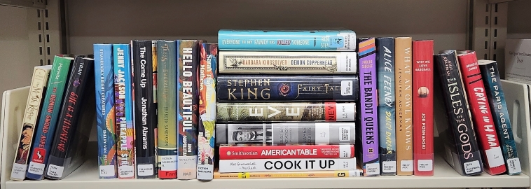 Row of stacked books on a shelf
