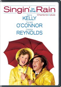 Woman and man in yellow raincoats under a red umbrella