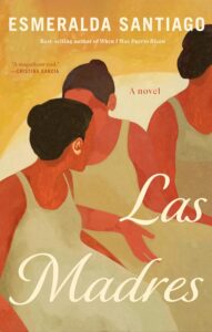 3 Hispanic women with hair in buns sitting together