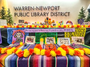 Close up photo of part of the library's community ofrenda showcasing pets that are being remembered on the ofrenda. 