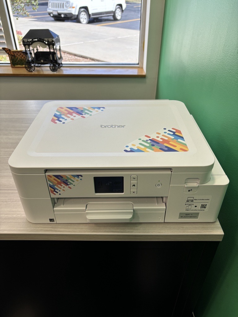 A white printer that uses specific ink to create designs you can then heat transfer to items.