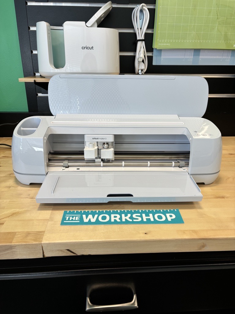 A light blue Cricut machine used to cut intricate designs on paper and vinyl stickers.