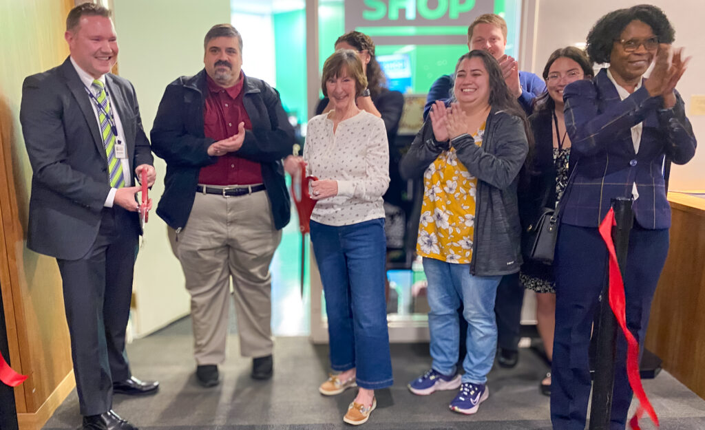 Group of people celebrating the ribbon cutting of the library's makerspace, The Workshop