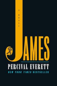 An image of the book cover for “James” by Percival Everett. The title word “James” is written in yellow against a black background and sits in the middle of the cover. The “J” in the title is elongated to the very top of the cover. In the curve of the “J” there is a drawn deption of a man with a knapsack.  
