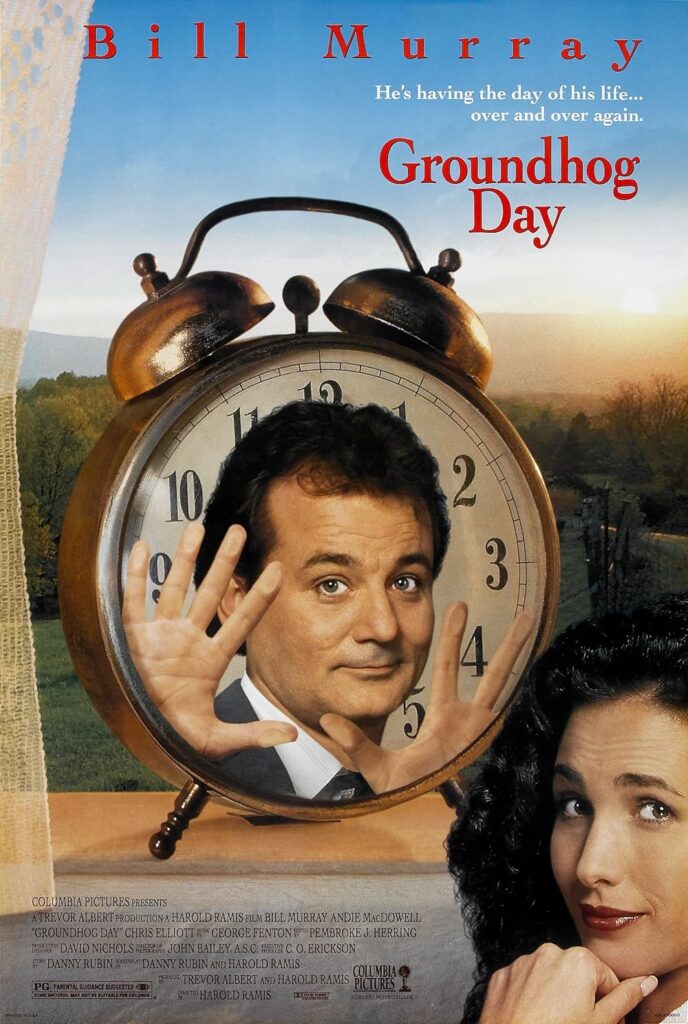 Cover for Groundhog Day movie. Man's face stuck inside a clock while he holds up five fingers. Woman creeps out of the corner with a curious look. Background is a sun setting over a field.