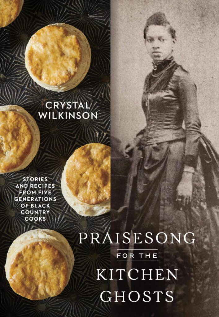 An image of the book cover for “Praisesong for the Kitchen Ghosts” by Crystal Wilkinson. Half the cover features four biscuits that are spread out along a black background. The second half features a vintage portrait of a young black woman in a dress that is approximately dated during the American Civil War.