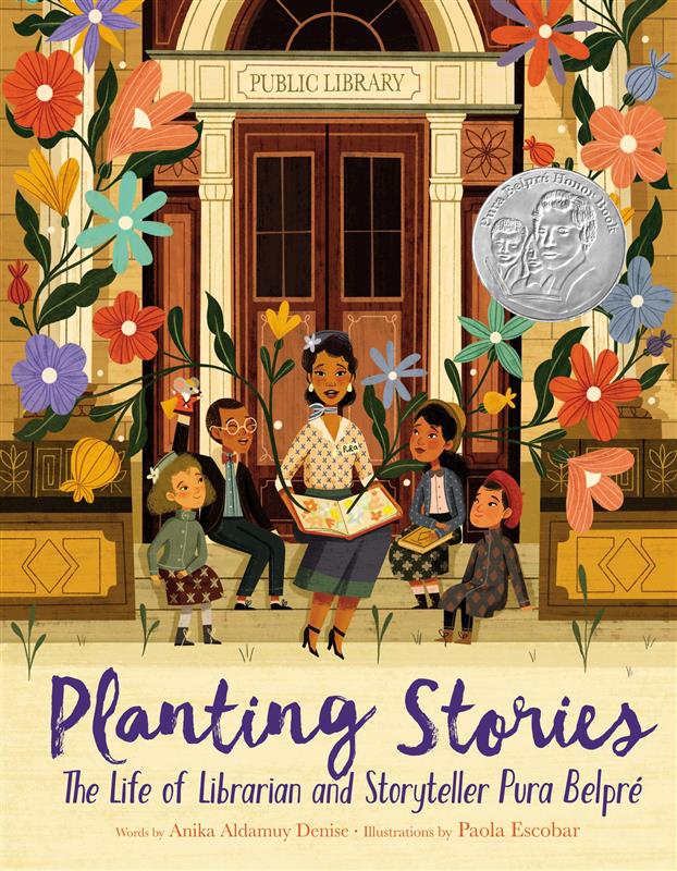 An image of the book cover for “Planting Stories” by Anika Aldamuy Denise. A drawn depiction of a woman reading a book to four children on the stoop of a public library. Large stemmed flowers bloom out of the open book on the lady’s lap. 