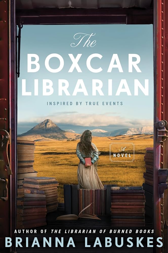 Book cover for the Boxcar Librarian. Woman stands in the middle of boxcar as it passes mountain and wheat fields.