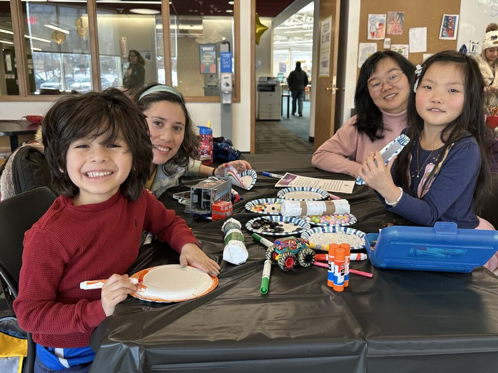Photo of happy families at a library program in the Vault