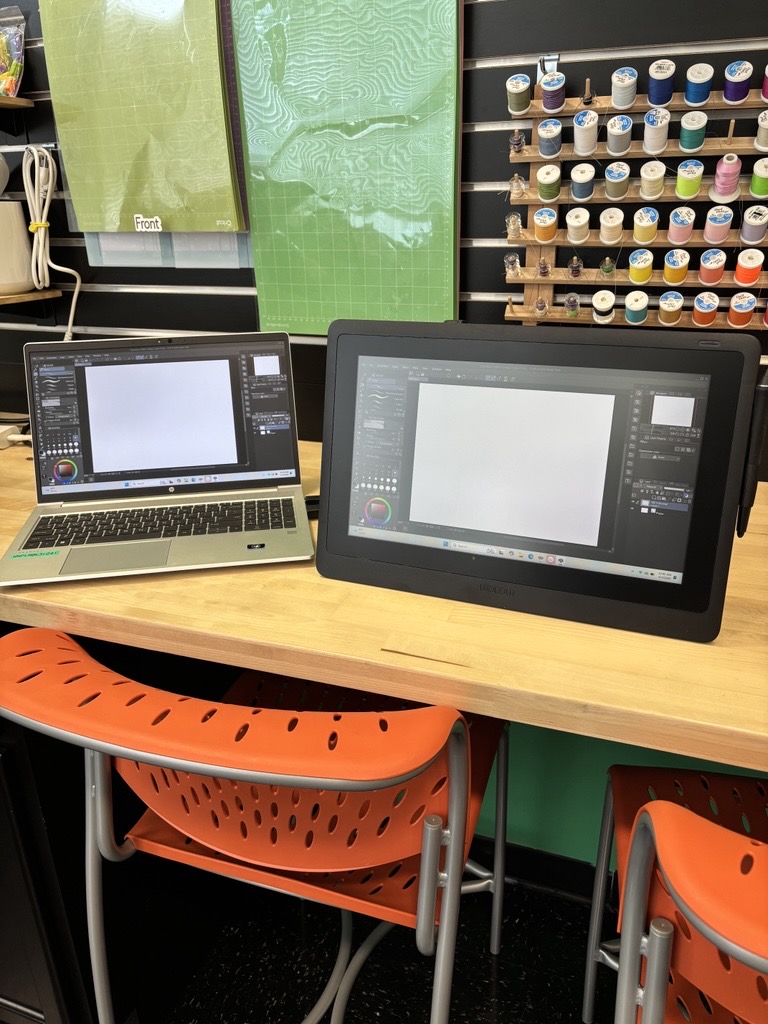 Large drawing tablet connected to a laptop with use of digital drawing.