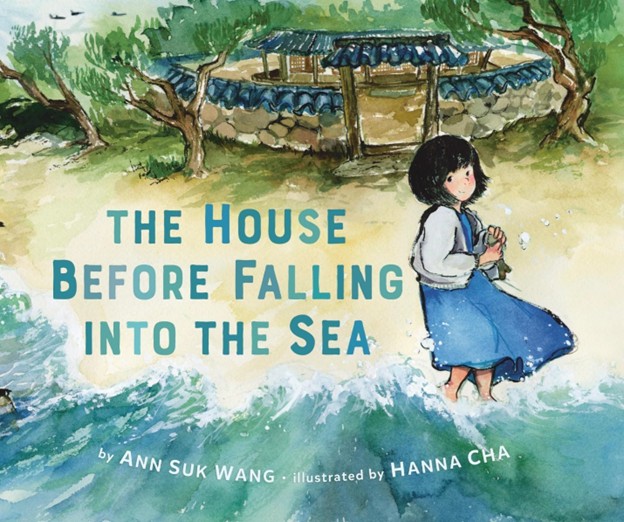 Young Korean girl in a blue dress standing in the water on a beach next to a boat.