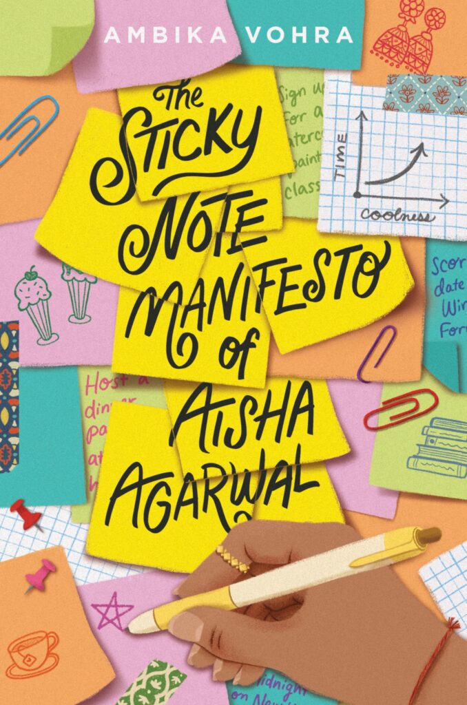 Table filled with sticky notes and paper clips with a hand holding a pen at the bottom part of image.